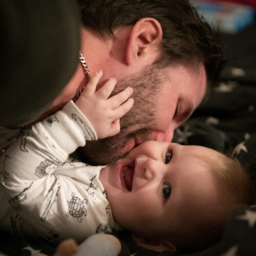 man kissing baby