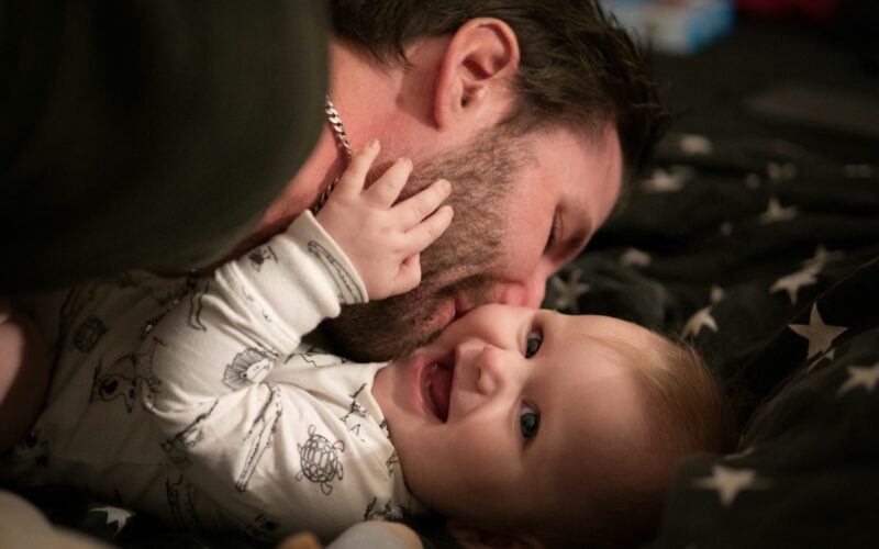 man kissing baby