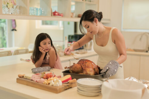 A mother and daughter preparing a turkey